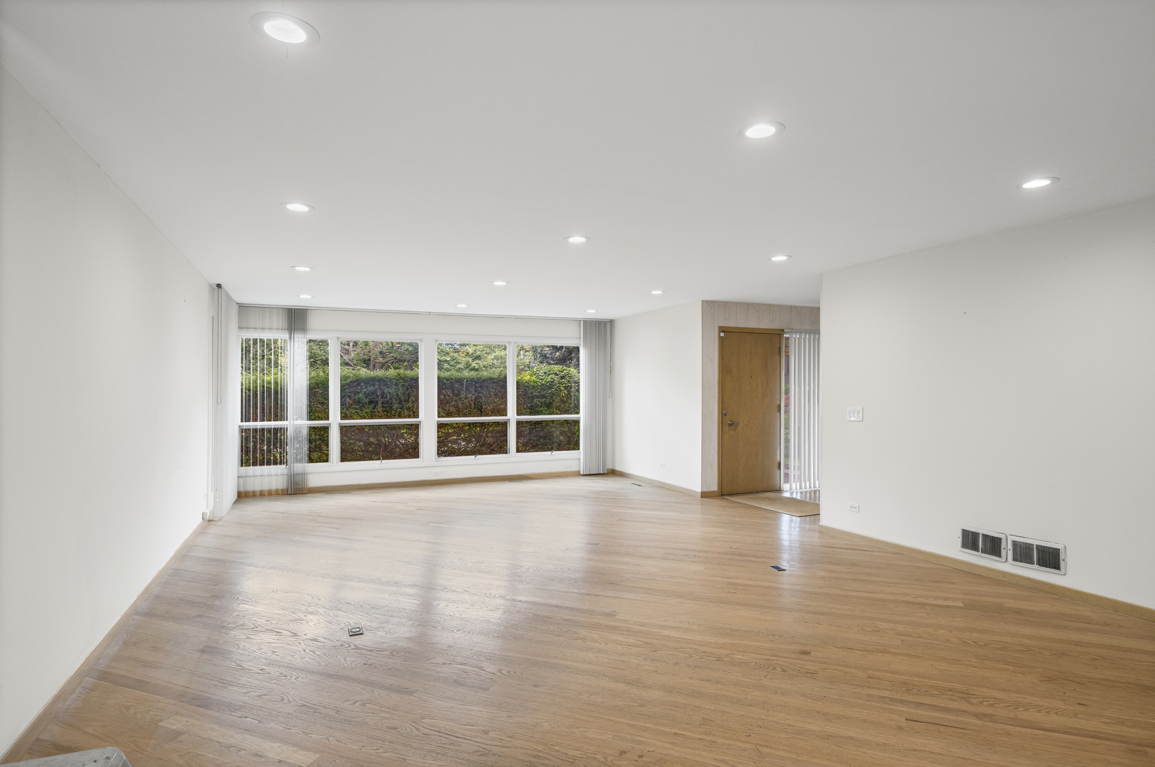 1125 Hohlfelder Road Glencoe, IL 60022 - Photo 3 of 25 a view of an empty room with wooden floor and a window