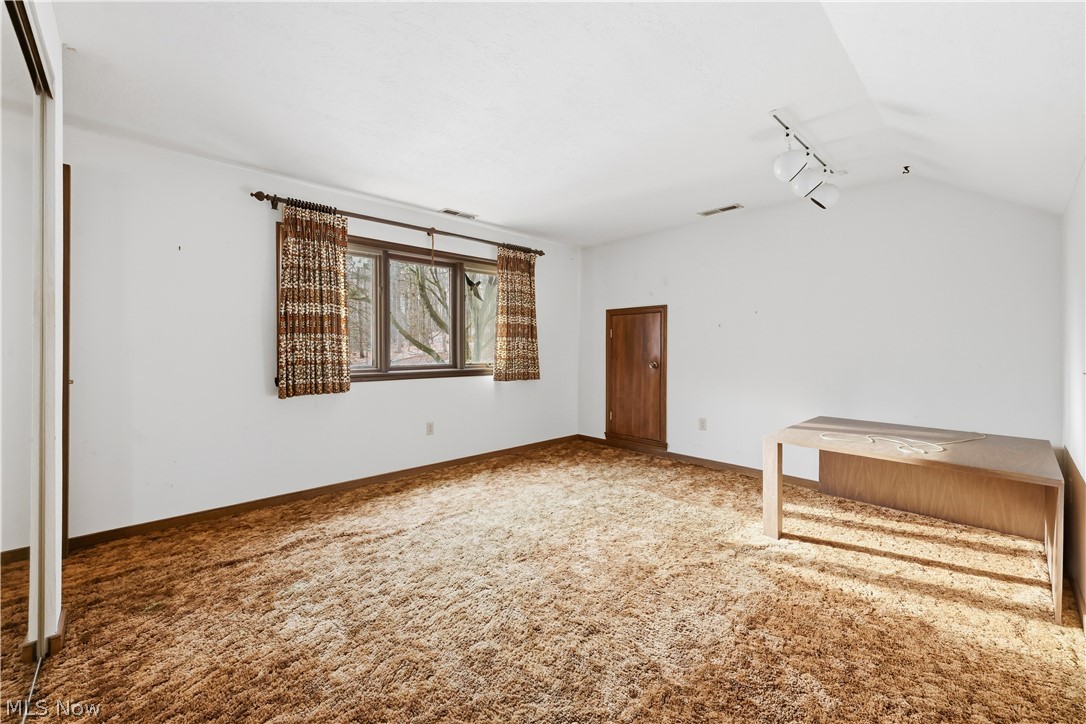 7014 River Styx Road Medina, OH 44256 - Photo 36 of 50 Carpeted spare room featuring lofted ceiling and track lighting