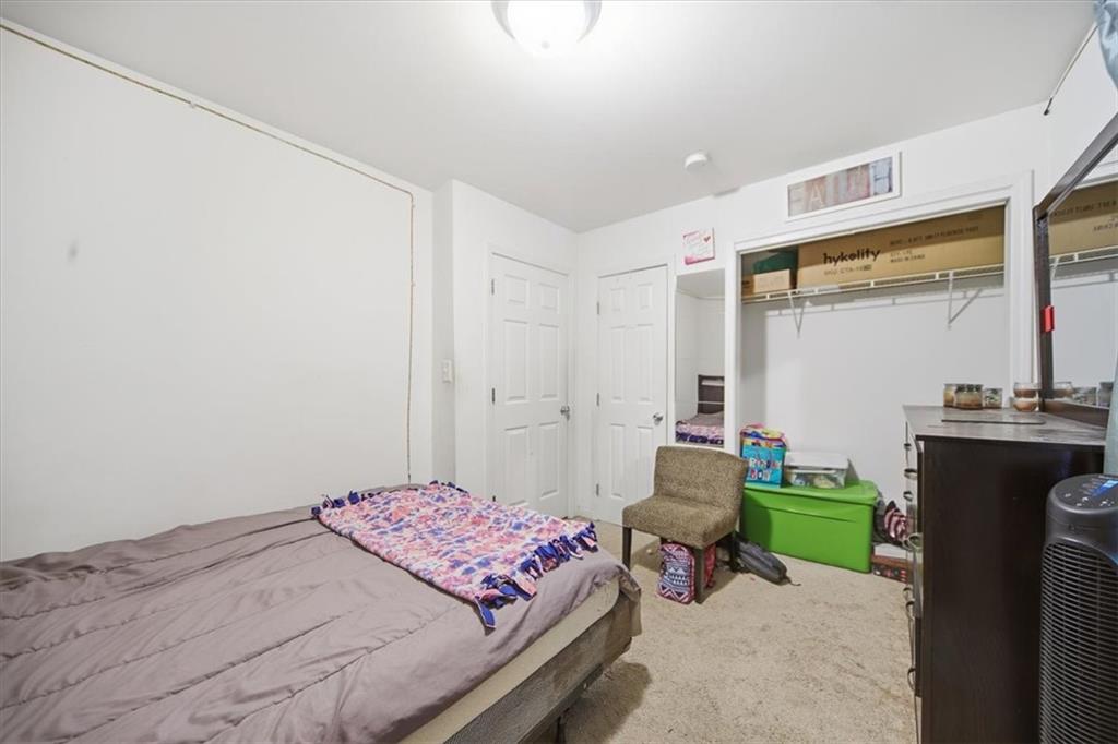 6283 Susan Lane Doraville, GA 30340 - Photo 15 of 34 a bedroom with a bed and a chair