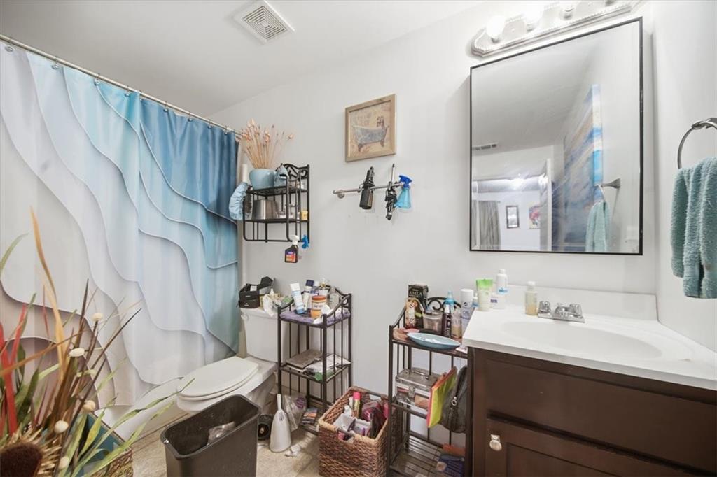 6283 Susan Lane Doraville, GA 30340 - Photo 17 of 34 a bathroom with a sink mirror and a toilet
