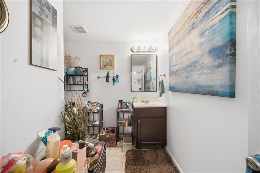 6283 Susan Lane Doraville, GA 30340 - Photo 22 of 34 a bathroom with a sink mirror and vanity