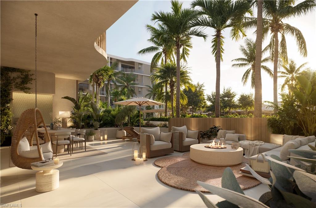 1933 Davis Boulevard, Unit 602 Naples, FL 34104 - Photo 12 of 18 a view of a patio with couches and table and chairs and potted plants