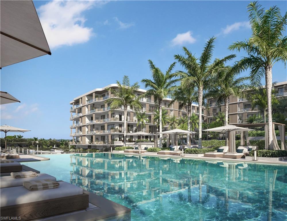 1933 Davis Boulevard, Unit 602 Naples, FL 34104 - Photo 16 of 18 a view of swimming pool with outdoor seating and lake view