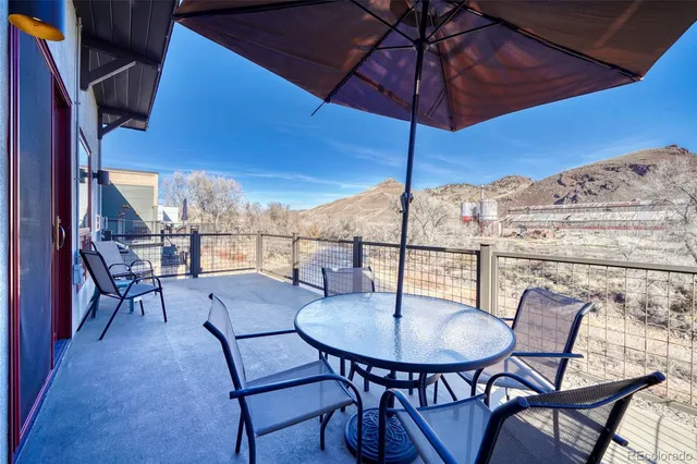 a balcony with a table and chairs