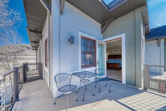 a view of a chairs and table in the balcony