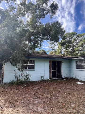 a backyard of a house with large trees