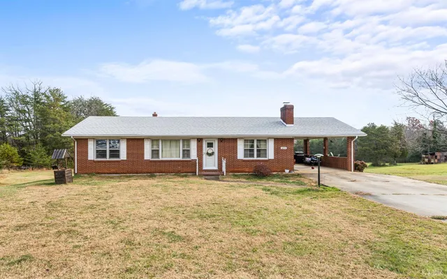 a house that has a tree in front of it