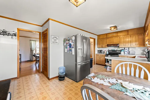 a kitchen with stainless steel appliances granite countertop a refrigerator and a sink