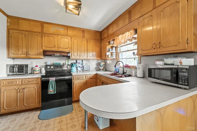 a kitchen with a sink cabinets and appliances