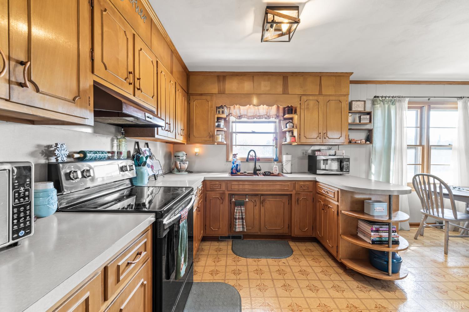 1872 Wards Road Hurt, VA 24563 - Photo 13 of 54 a kitchen with stainless steel appliances granite countertop a sink a stove and a refrigerator