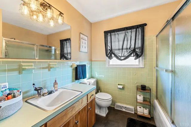 a bathroom with a sink mirror and toilet