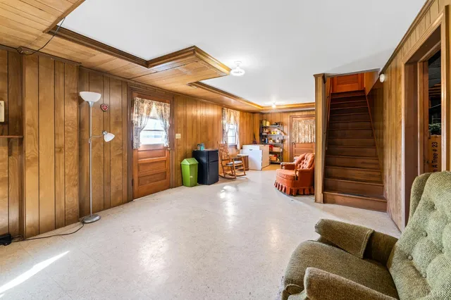 a view of hallway with furniture and a window