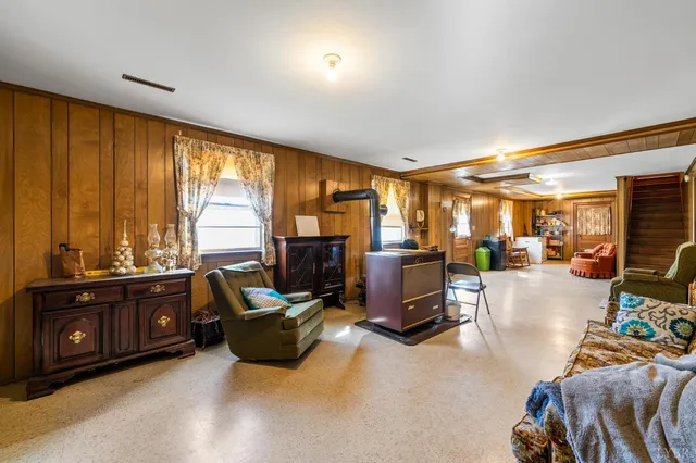 a living room with furniture a flat screen tv and a window