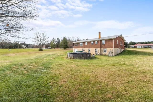a front view of house with yard and lake view