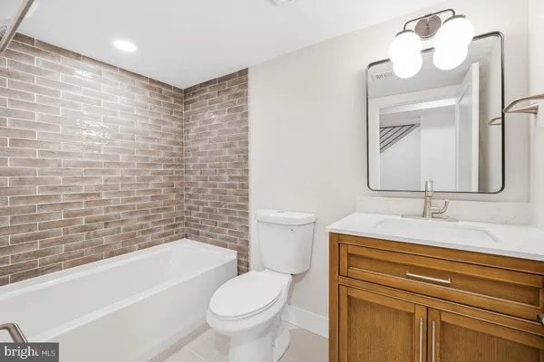 a bathroom with a sink a toilet and a bathtub