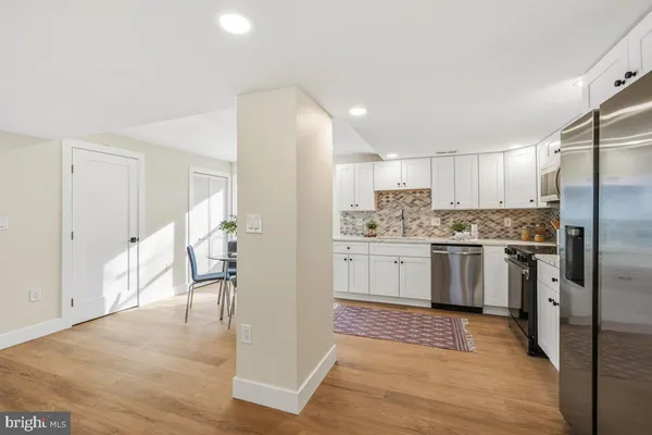 a kitchen with a refrigerator a sink and a stove top oven