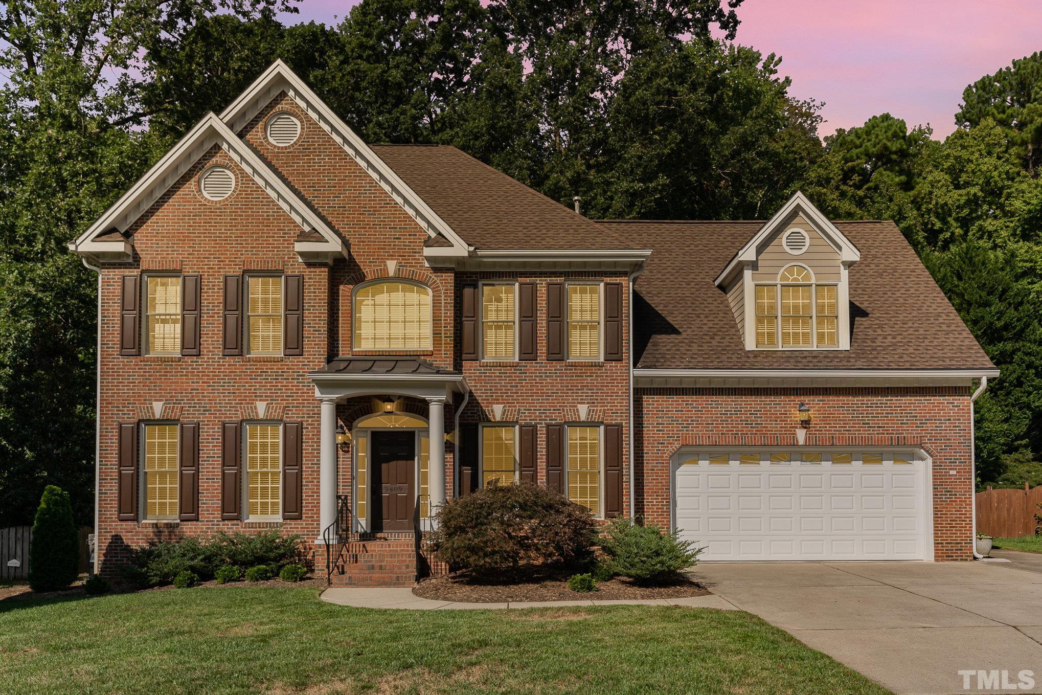9409 Stone Mountain Road Raleigh, NC 27613 - Photo 2 of 53 a front view of a house with a yard and trees