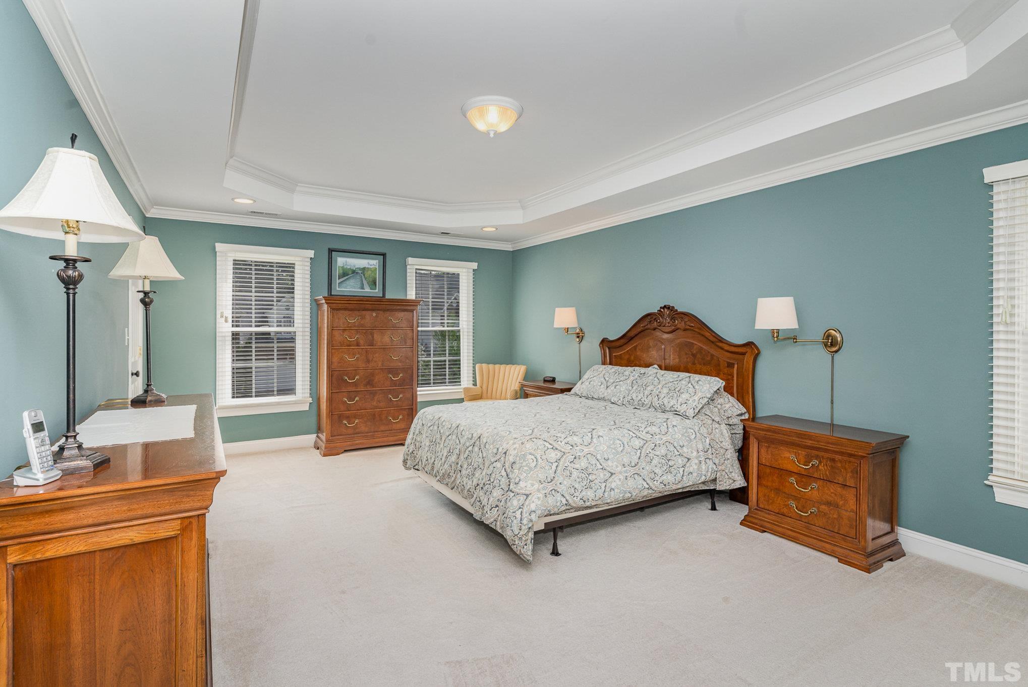 9409 Stone Mountain Road Raleigh, NC 27613 - Photo 21 of 53 a spacious bedroom with a bed and a dresser