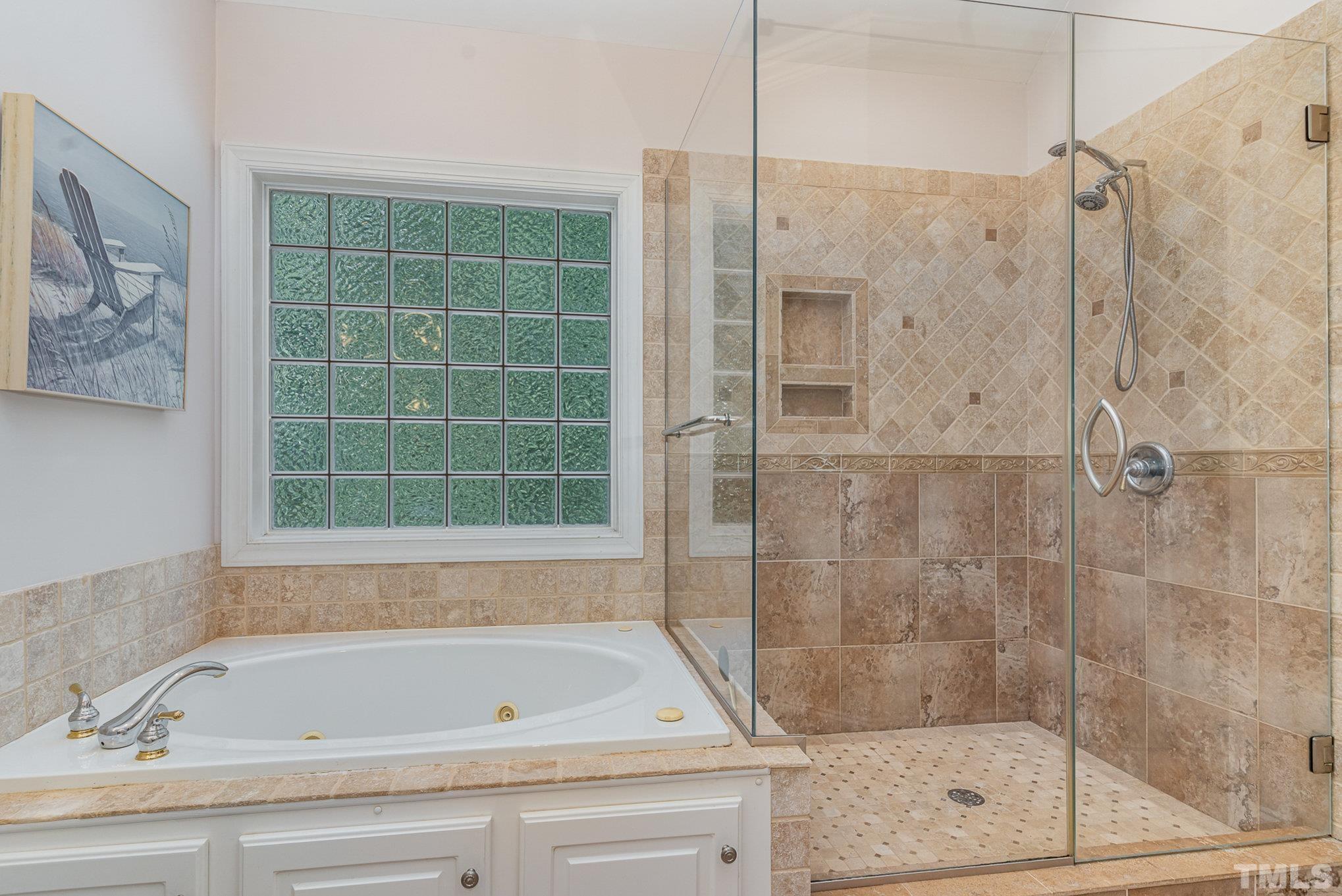 9409 Stone Mountain Road Raleigh, NC 27613 - Photo 24 of 53 a bathroom with a bathtub and a shower