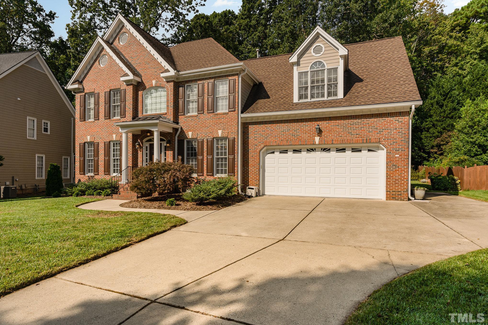 9409 Stone Mountain Road Raleigh, NC 27613 - Photo 3 of 53 a front view of a house with a yard and garage