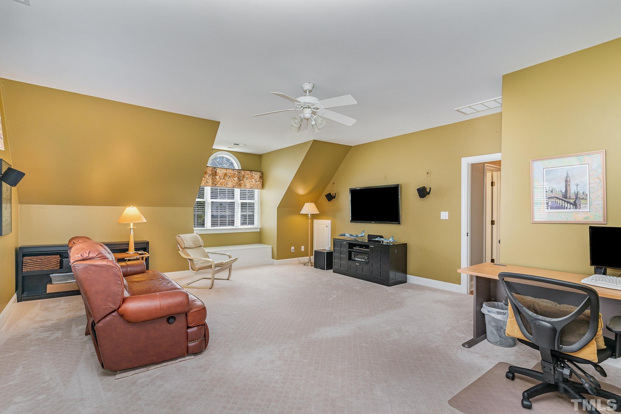 9409 Stone Mountain Road Raleigh, NC 27613 - Photo 32 of 53 a living room with furniture and a flat screen tv
