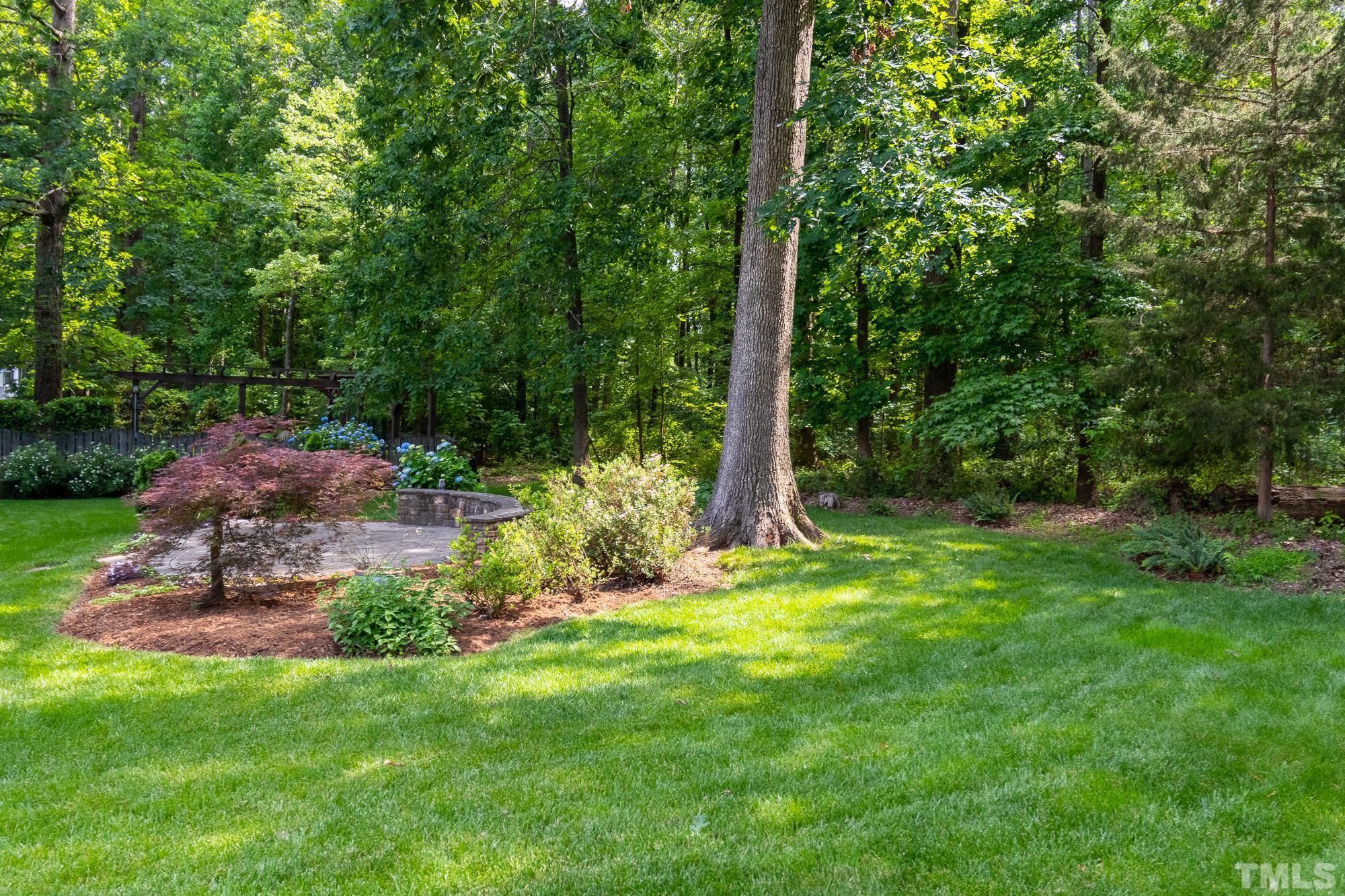9409 Stone Mountain Road Raleigh, NC 27613 - Photo 43 of 53 a view of a backyard with a garden