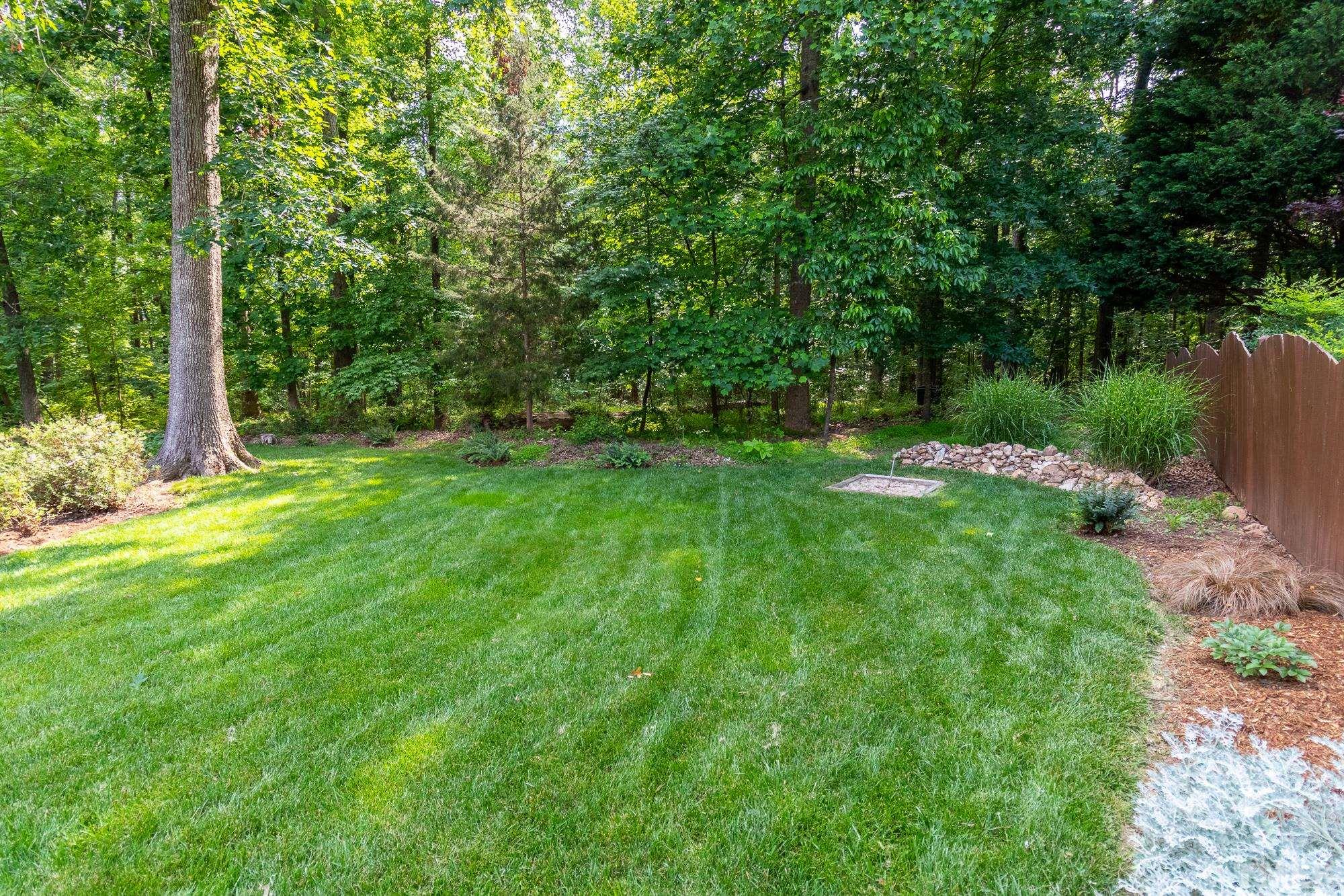 9409 Stone Mountain Road Raleigh, NC 27613 - Photo 44 of 53 a backyard of a house with lots of green space