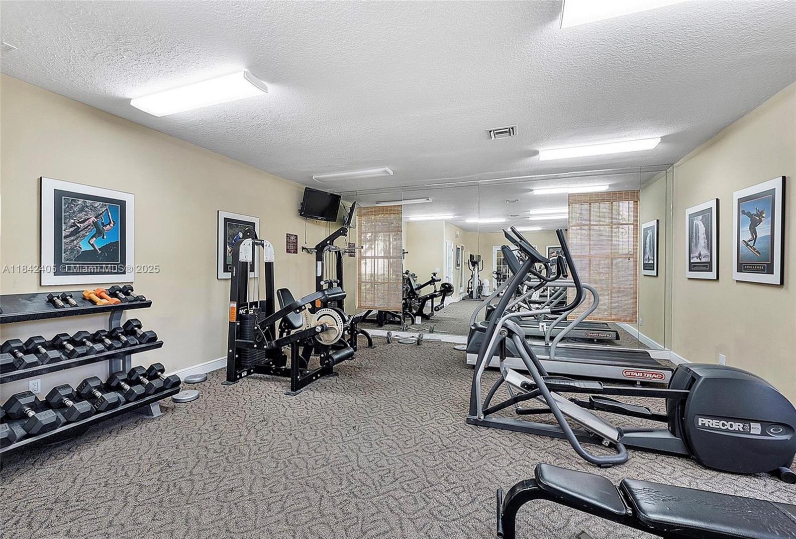 1239 Southwest 46th Avenue, Unit 906 Pompano Beach, FL 33069 - Photo 19 of 21 a view of a room with gym equipment