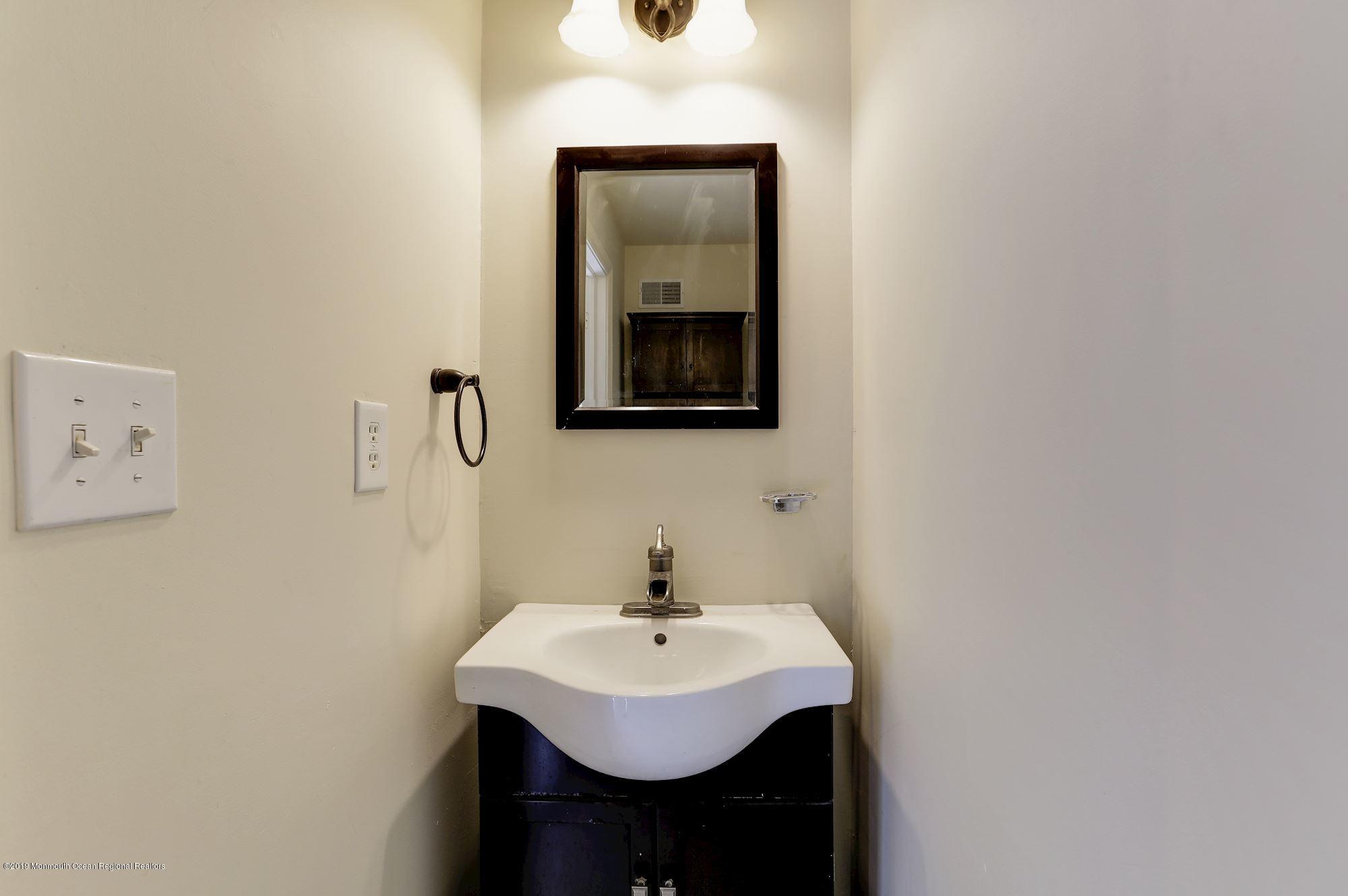 460 Cedar Swamp Road Jackson, NJ 08527 - Photo 18 of 38 a bathroom with a sink and a mirror