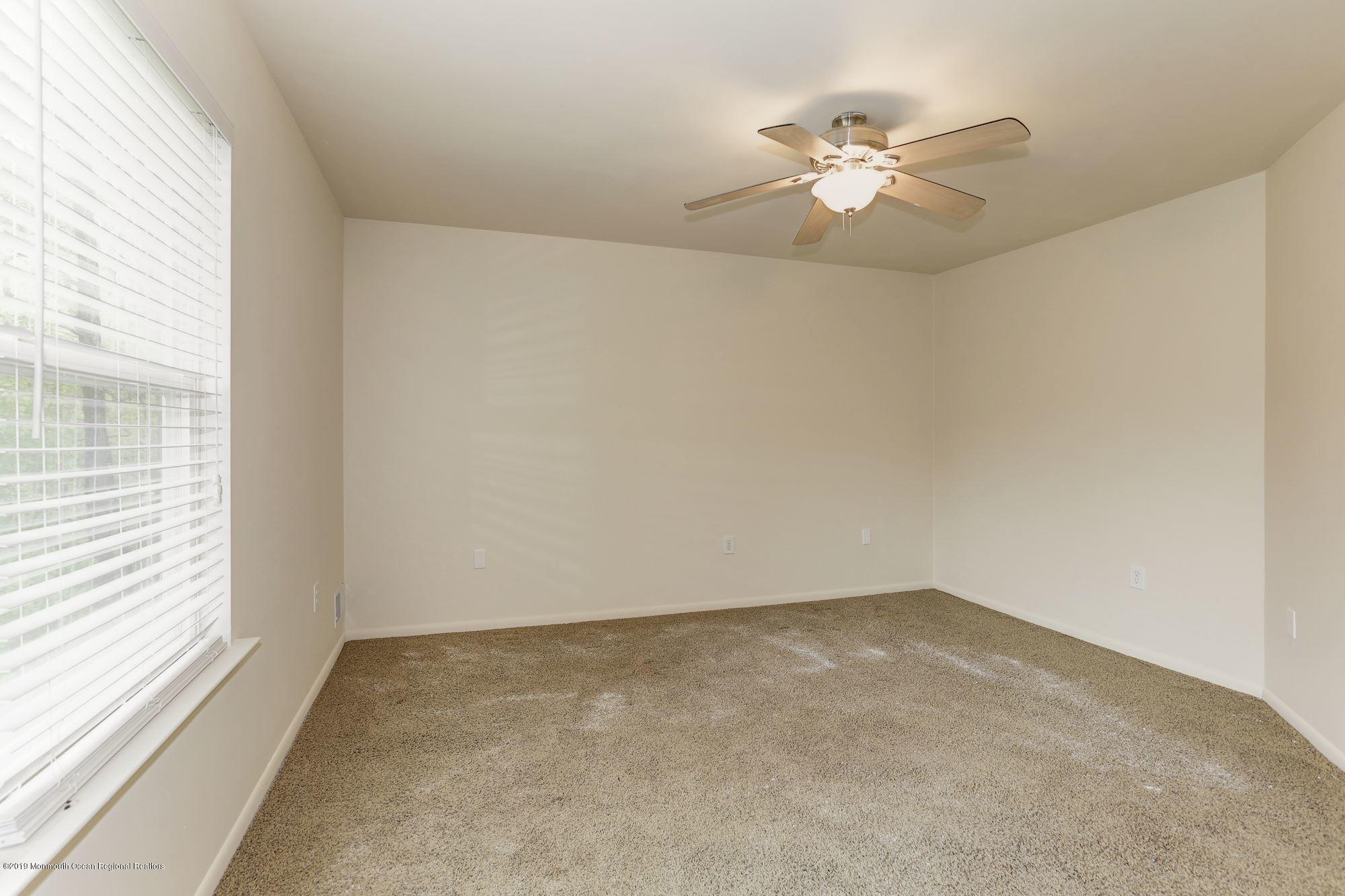 460 Cedar Swamp Road Jackson, NJ 08527 - Photo 21 of 38 an empty room with a window and a fan