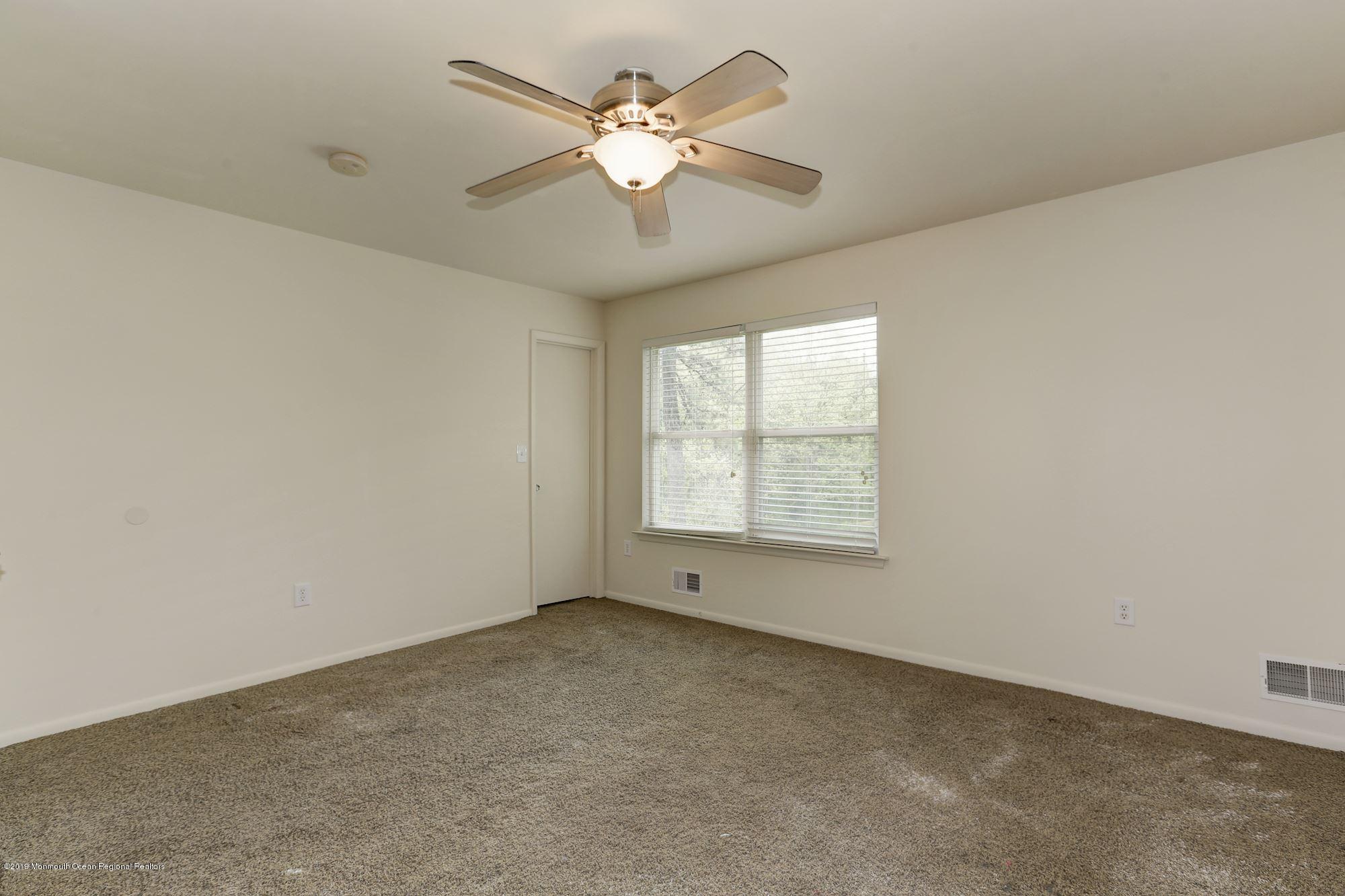 460 Cedar Swamp Road Jackson, NJ 08527 - Photo 22 of 38 an empty room with windows and fan