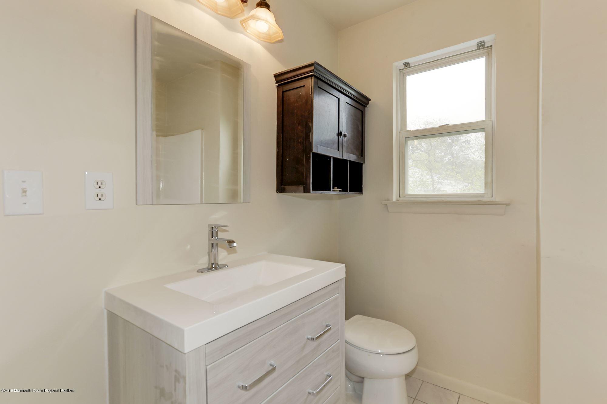 460 Cedar Swamp Road Jackson, NJ 08527 - Photo 25 of 38 a bathroom with a toilet sink and mirror