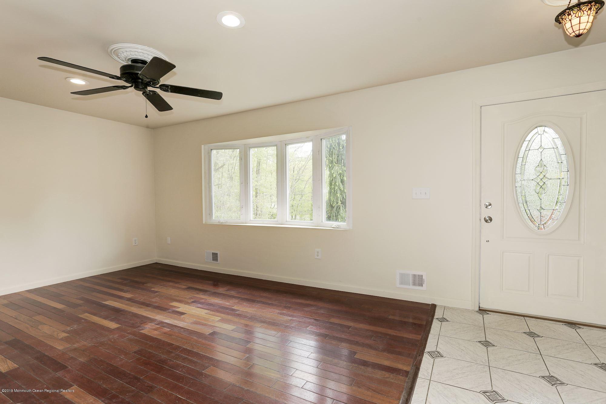 460 Cedar Swamp Road Jackson, NJ 08527 - Photo 3 of 38 an empty room with windows and fan