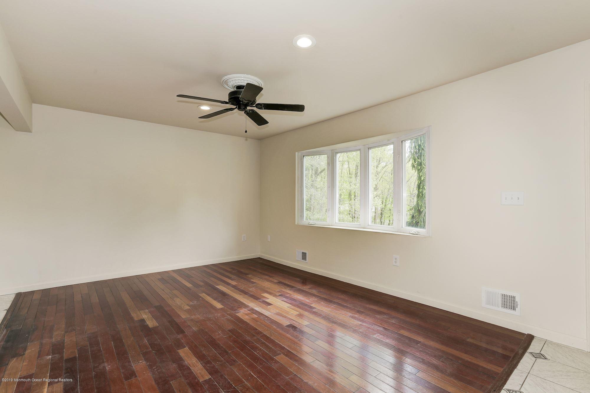 460 Cedar Swamp Road Jackson, NJ 08527 - Photo 5 of 38 wooden floor in an empty room with a window