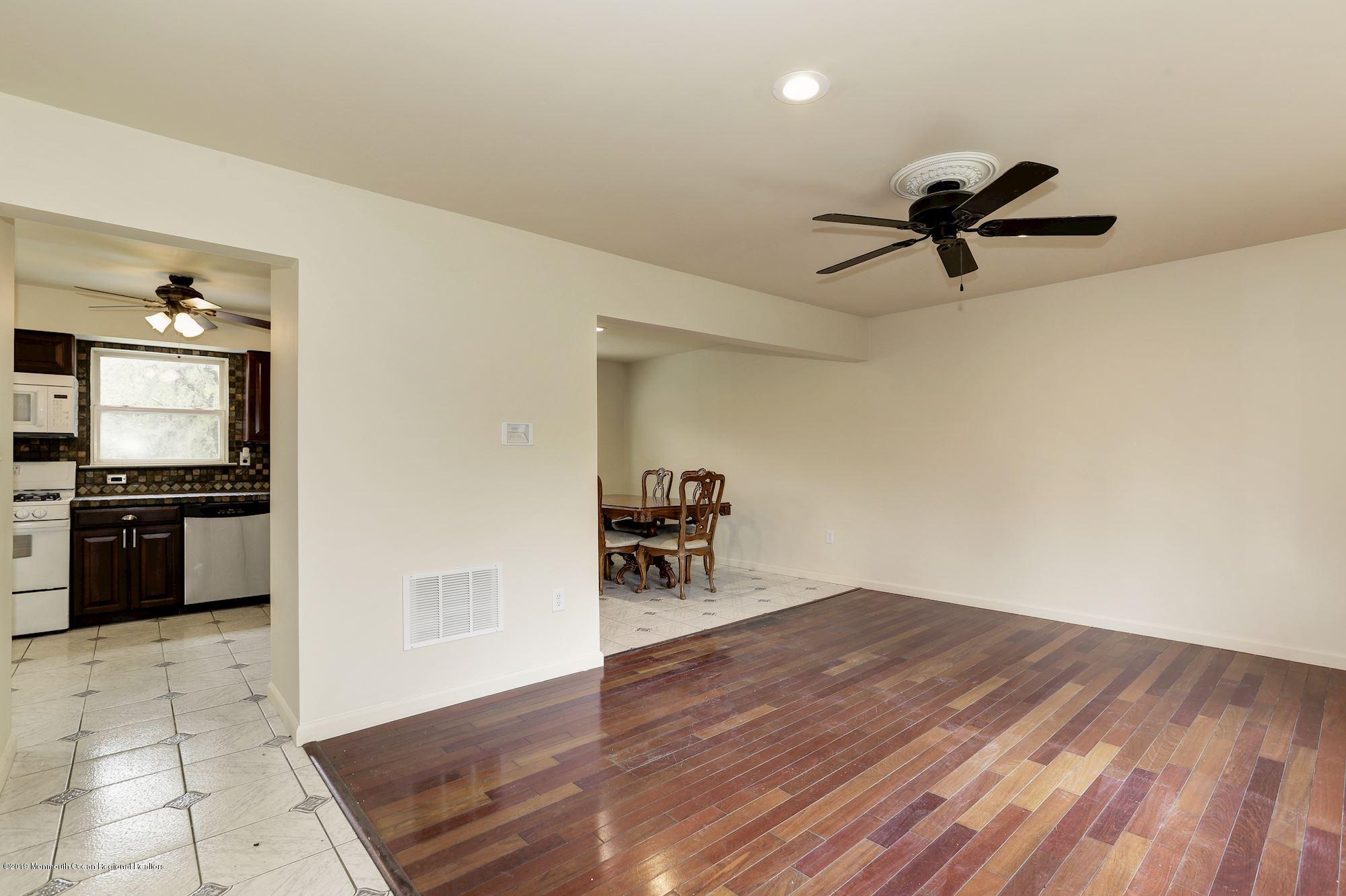 460 Cedar Swamp Road Jackson, NJ 08527 - Photo 6 of 38 a view of a living room hardwood floor and a ceiling fan
