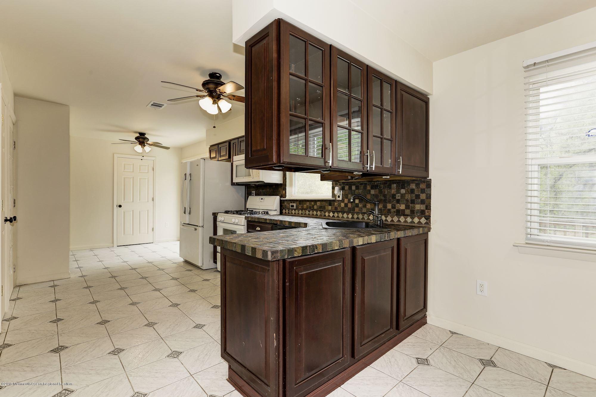 460 Cedar Swamp Road Jackson, NJ 08527 - Photo 10 of 38 a kitchen with stainless steel appliances granite countertop a stove a sink and a refrigerator