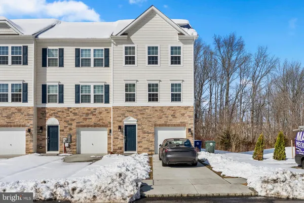 a car parked in front of a brick house