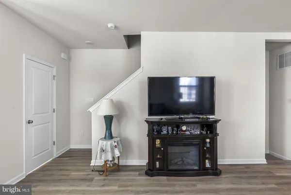 a kitchen with kitchen island granite countertop a refrigerator stove top oven and sink