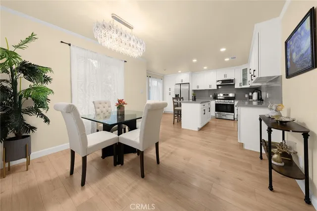 a dining room with furniture and wooden floor