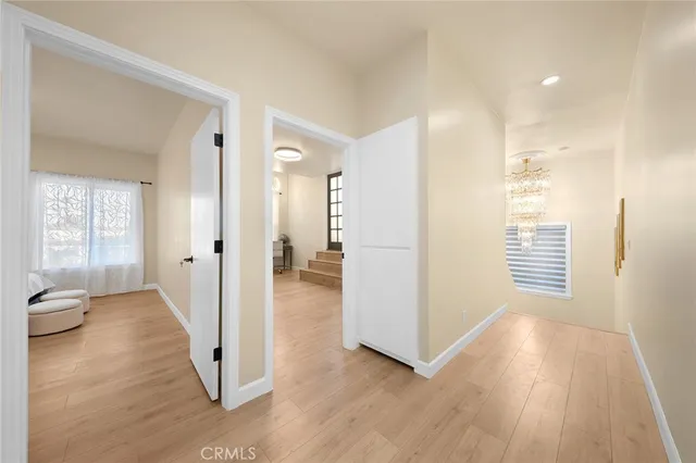 a view of a hallway with wooden floor and glass door