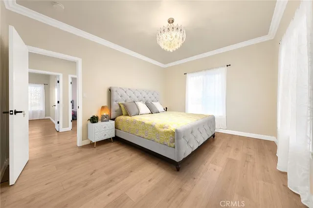 a bedroom with a bed and a chandelier