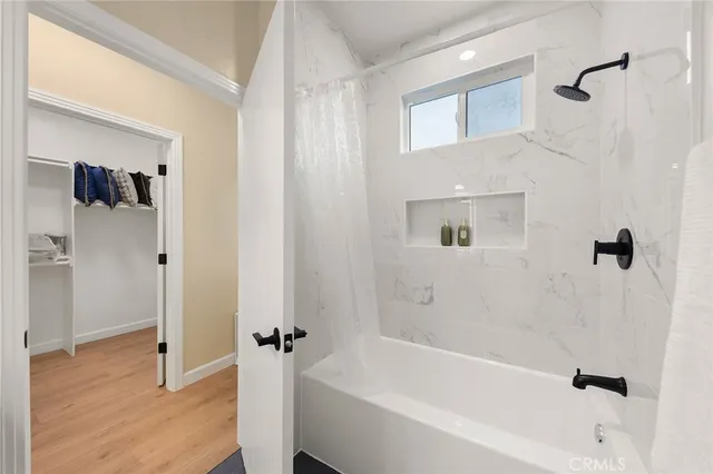 a bathroom with a bathtub and a shower