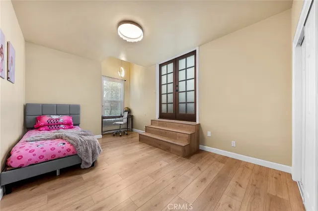 a bedroom with furniture and a wooden floor
