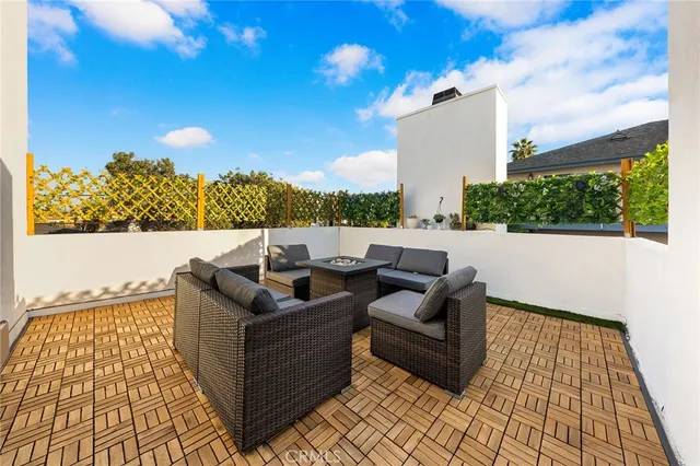 a view of a terrace with couches and sky view
