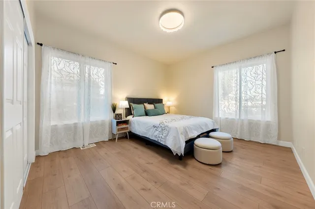 a bedroom with a bed and wooden floor