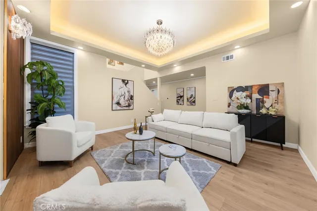 a living room with furniture and a chandelier