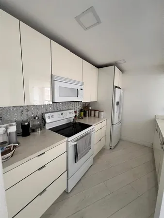 a kitchen with a sink cabinets and window