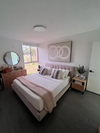 a bedroom with bed and window