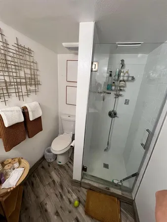 a bathroom with a toilet sink and shower