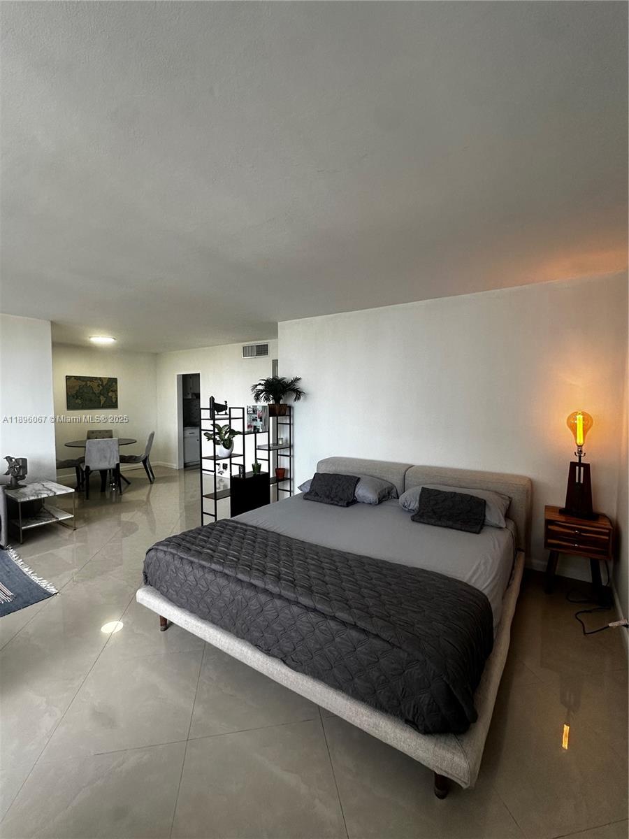 1200 West Avenue, Unit 914 Miami Beach, FL 33139 - Photo 11 of 38 a bedroom with a bed couch and a view living room